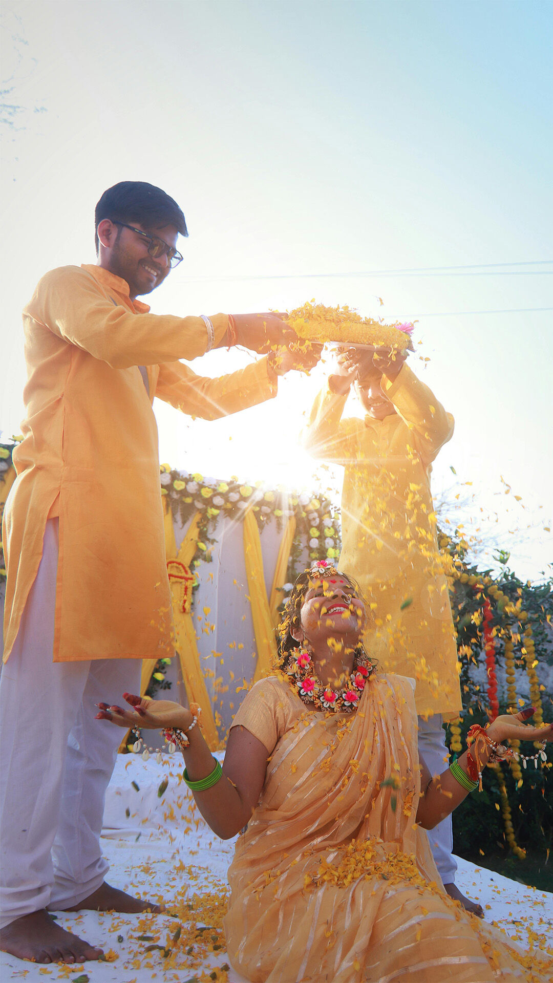 brothers of bride throwing yello flowers platelates on bride